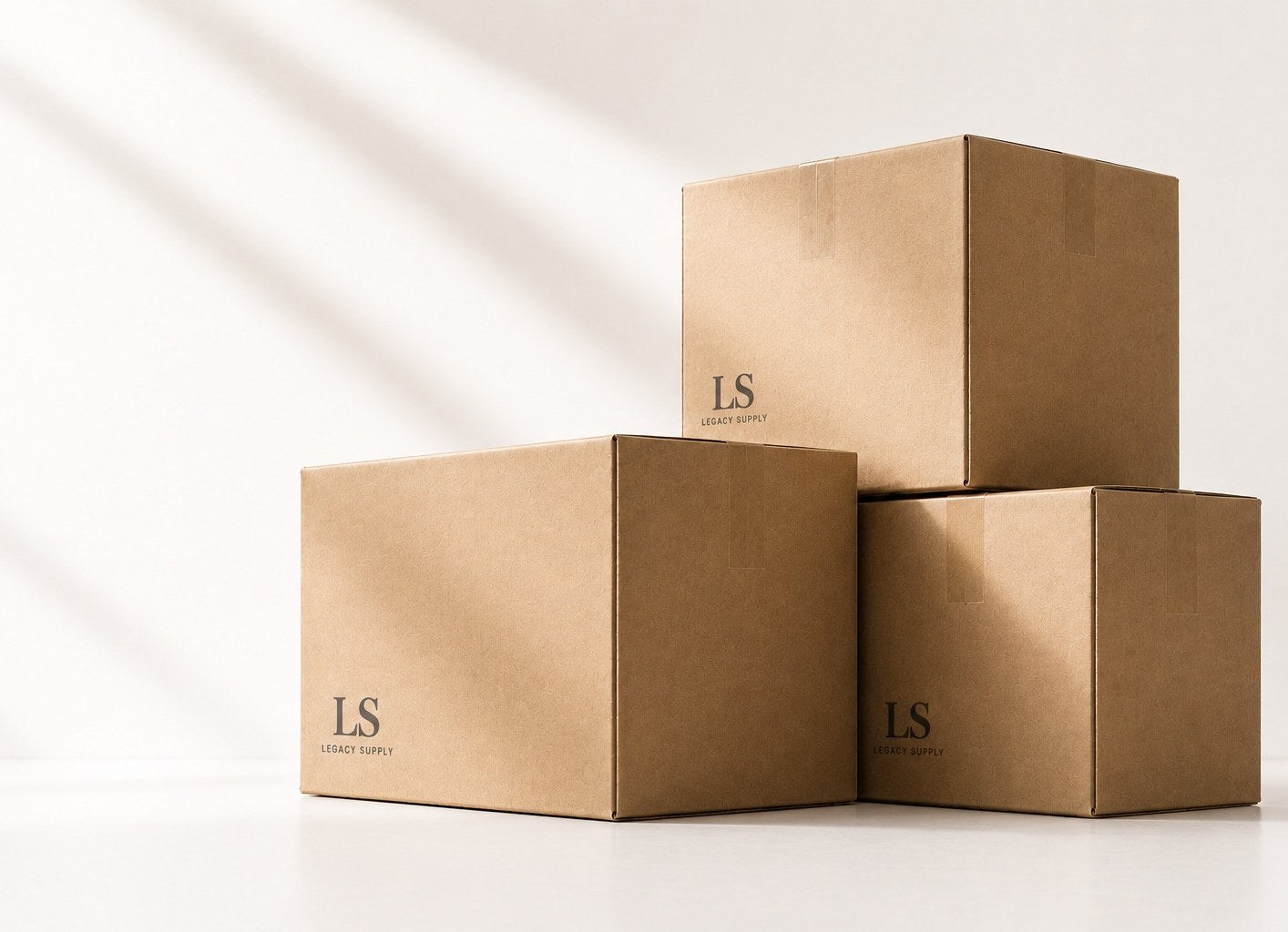 Stacked kraft shipping boxes printed with the Legacy Supply mark